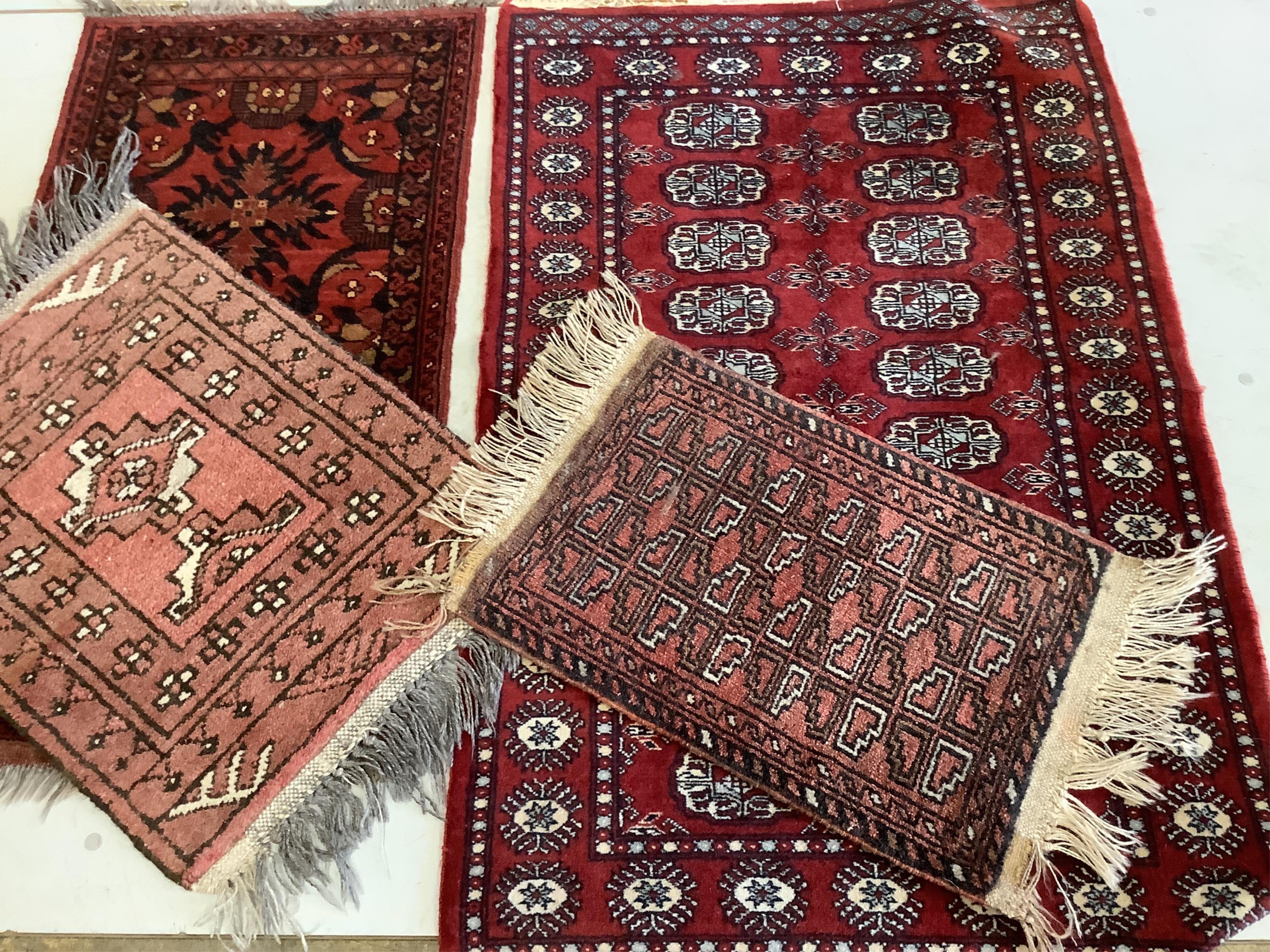 Four assorted Bokhara and Belouch mats, largest 120 x 78cm. Condition - fair